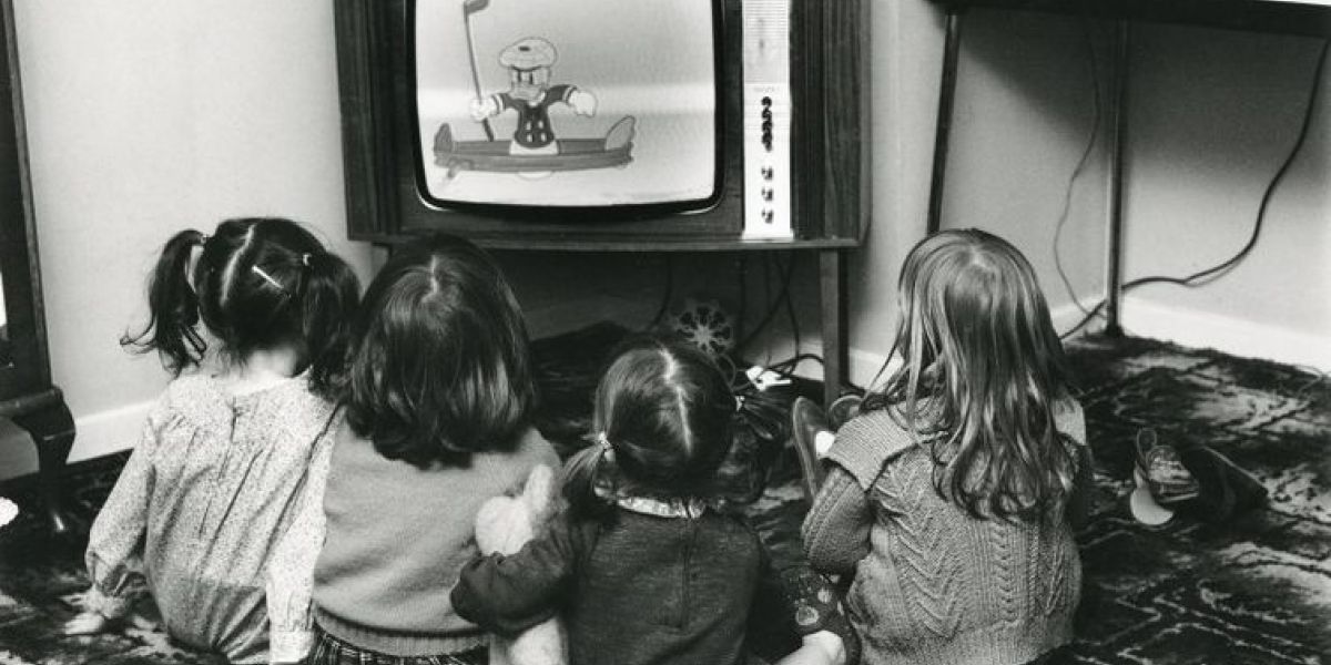 Four children sat looking at a TV Screen