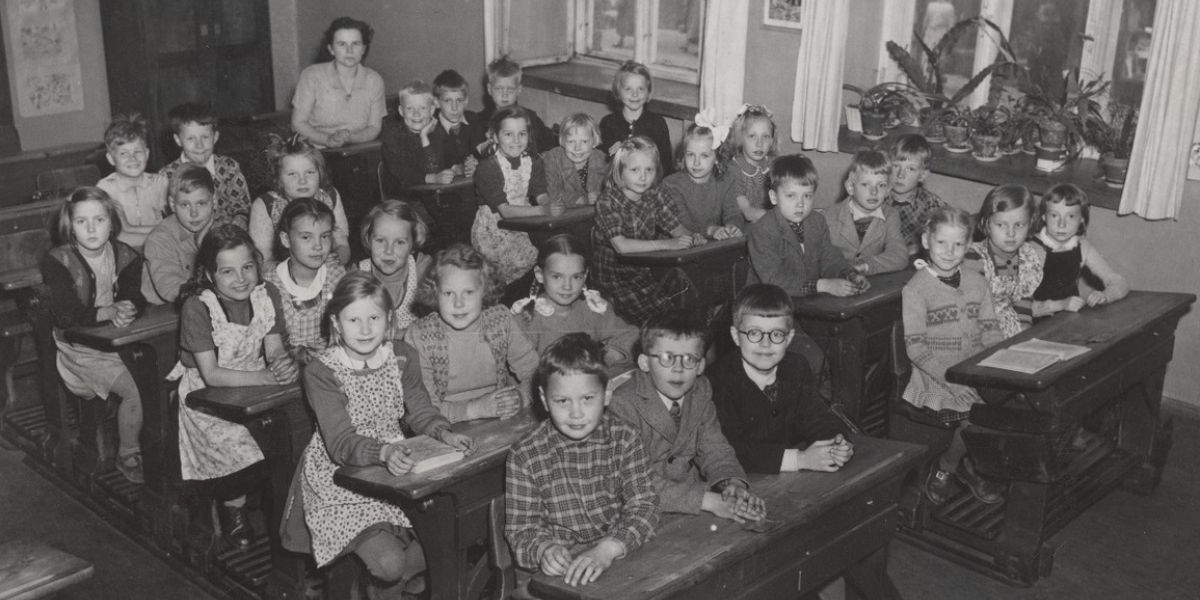 A group of children sat at desks