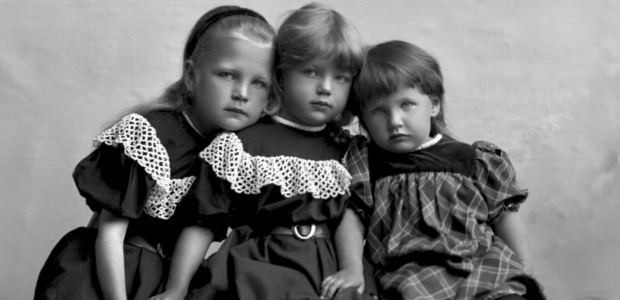A black and white photograph of three children