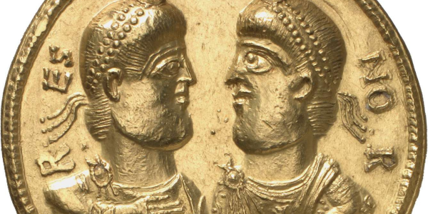 A gold coin with two men's heads on it