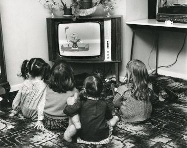 Children sat on the floor watching television