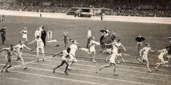 People pass batons during a race in the Olympic Stadium