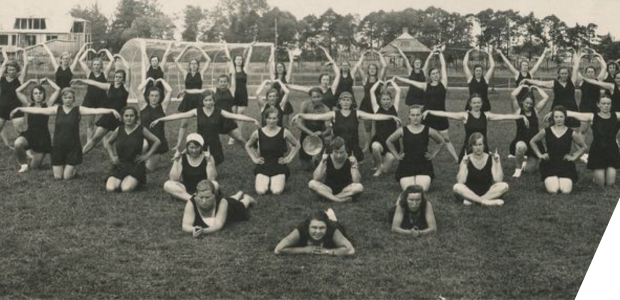 People taking part in a gymnastics display on a sports field