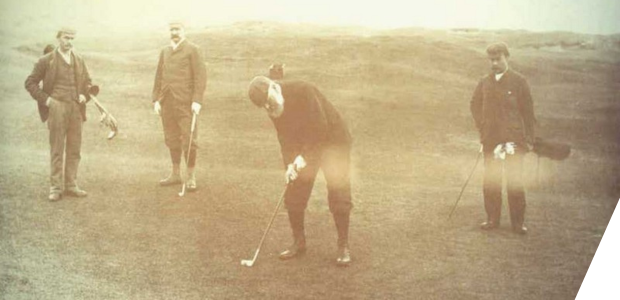Photograph of four people playing golf