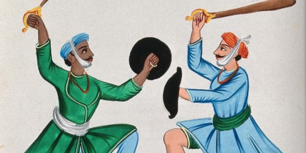Two Sikh men dueling with wooden swords.