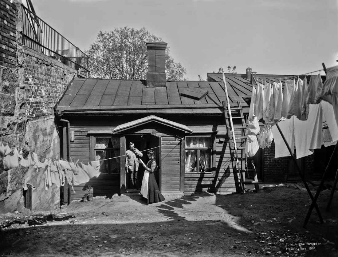 A front view of a house and a yard with washing hung up to dry