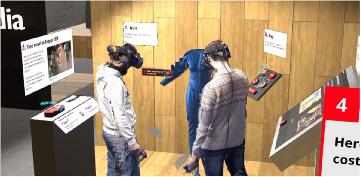 Two people wearing VR googles looking at a blue suit and virtual museum information boards