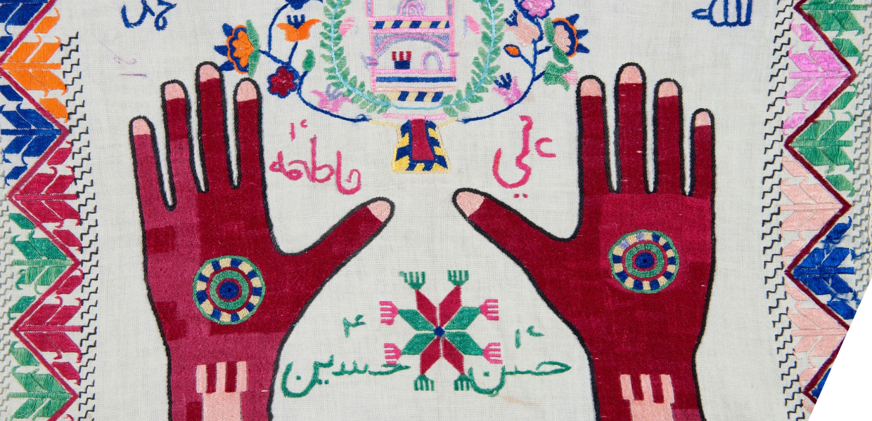 Embroidered cloth with pictures of hands with light pink nails and a round motive on the back of the hand.