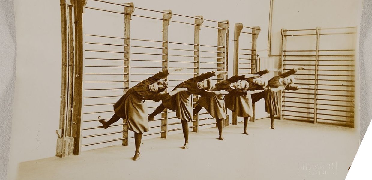 A row of people doing exercises against wall bars