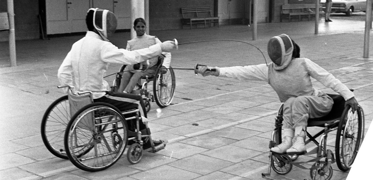 People in wheelchairs fencing
