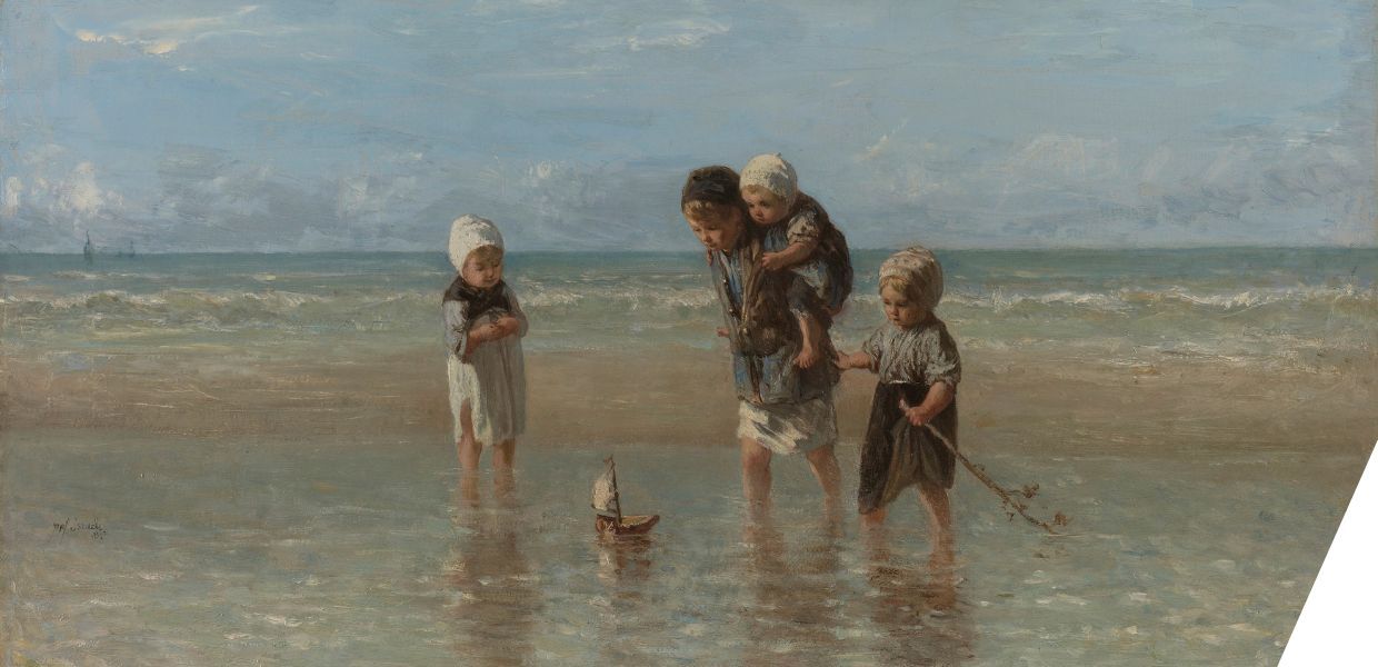 Three children paddling in the sea look at a small, toy boat. The largest child is carrying a smaller child on their back.