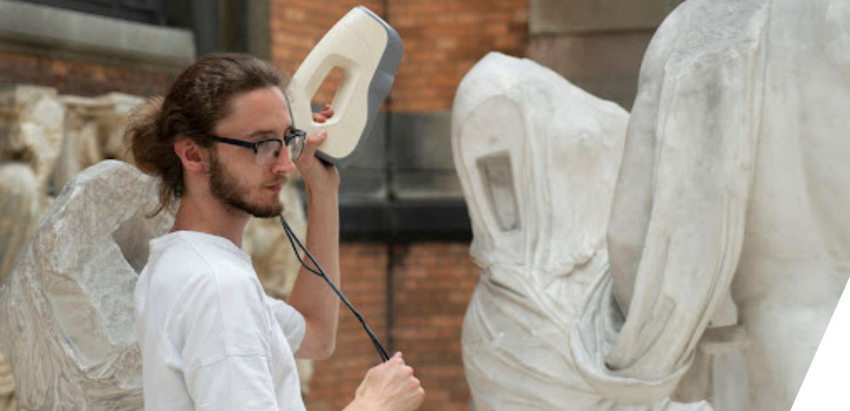 A statue being 3D-scanned with a handheld device