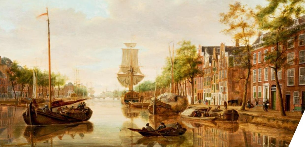 View of the Leuvehaven harbour in Rotterdam. A calm harbour with small and large sailing ships, next to a street with tall, elegant houses and trees. 