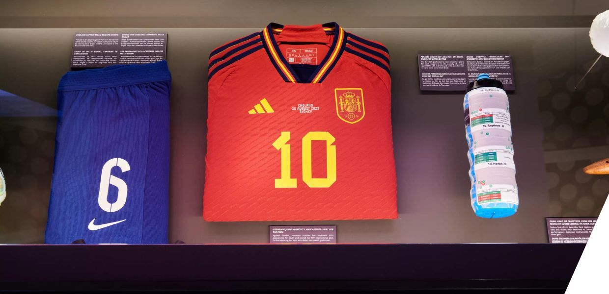 A display cabinet showing number 6 shorts, number 10 football shirt and a water bottle