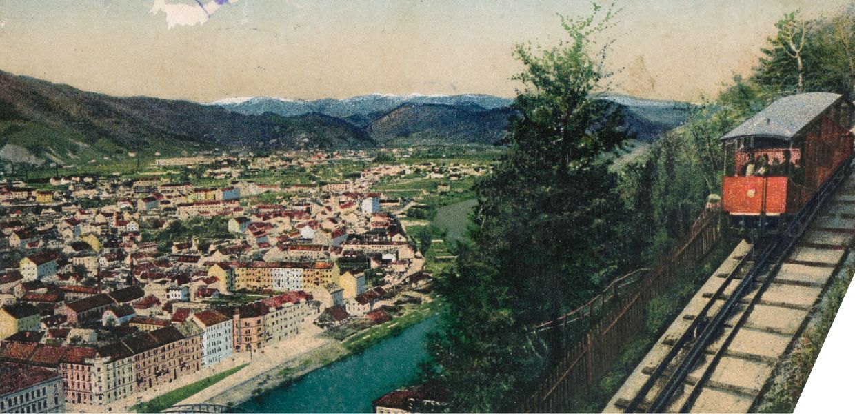 A view of Graz with a train and train tracks on the right hand side