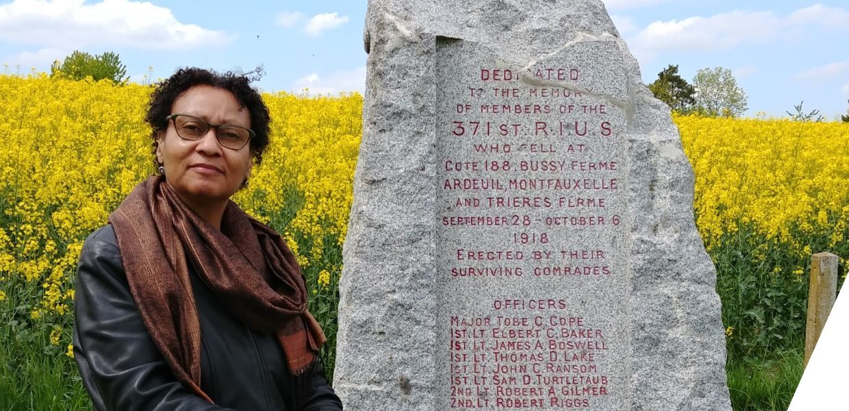 Julia standing beside a WW1 marker honouring African American soldiers in Eastern France